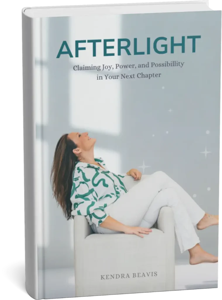 A hardcover book titled AFTERLIGHT by Kendra Beavis. The cover features a geometric, faceted butterfly in gold and purple tones, with sparkles around it, and a soft gradient background.